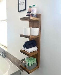 a bathroom shelf with towels, toiletries and other personal care items on it next to a bathtub