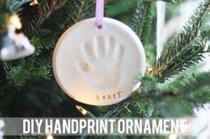 an ornament hanging from a christmas tree with the words diy handprint ornaments on it