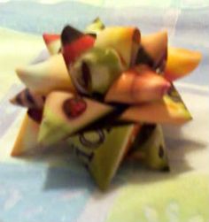 a close up of a bunch of fruit on top of a white table cloth with blue and green designs