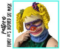 a woman wearing a crocheted clown mask