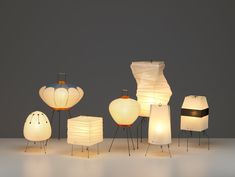 several different types of lamps sitting on top of a white table next to each other