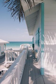 there is a white house on the beach