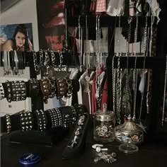 there are many necklaces and bracelets on the shelves in this room, all hanging up