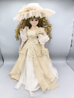 Very beautiful doll with fine porcelain arms and legs, long curly hair and lush eyelashes. She is dressed in a gorgeous creamy beige Victorian style dress and a huge hat. The dress is richly decorated with embroidered flowers.  The height of the doll is 48 centimetres. Sold with a stand. A gift for a collector, a child, vintage room decoration. Victorian Fashion Dresses, Thought Daughter, Vintage Porcelain Dolls, Dress With Flowers, Vintage Room Decor, Vintage Room, Porcelain Doll, Long Curly Hair, Fine Porcelain