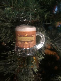 a beer mug ornament hanging from a christmas tree