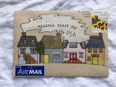 an airmail envelope with houses and flowers on it