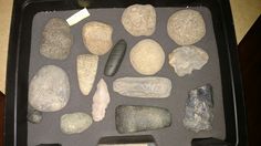 various rocks and stones in a black tray