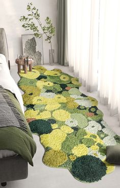 a bedroom with green and yellow rugs on the floor next to a bed in front of a window