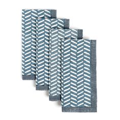 four blue and white chevroned napkins on top of each other, one with an arrow pattern