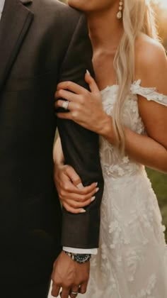 a bride and groom holding each other close together