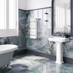 a bathroom with marble flooring and walls in shades of blue, grey and white