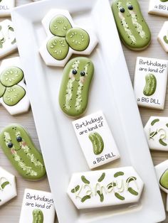 cookies decorated with green and white frosting are on a plate next to the words happy birthday