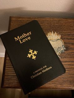 a mother love book sitting on top of a wooden table