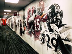 the hallway is decorated with football uniforms and helmets