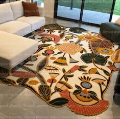 a living room with a large rug on the floor