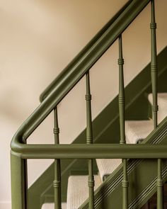 the stairs are painted green and have white cushions