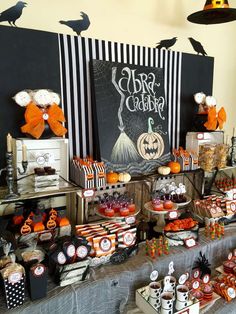 a table filled with lots of halloween treats