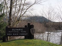 there is a sign that says olympic national park and hoh rain forest in the background