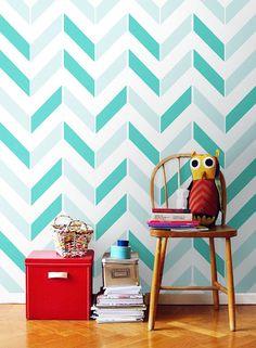 an owl stuffed animal sitting on top of a chair next to a stack of books