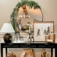 a table topped with lots of christmas decorations and decorating items next to a mirror