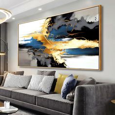 a living room filled with furniture and a large painting on the wall above it's couch