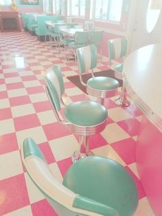 a diner with checkered floor and blue chairs