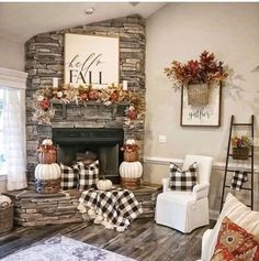 a living room filled with furniture and a fire place covered in fall decorations on top of a wooden floor