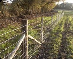 a wire fence in the middle of a field