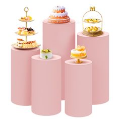 there are many different cakes on top of the pink pedestals, each with a cake stand