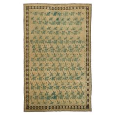 an antique rug with blue and green floral designs on the bottom, in white background