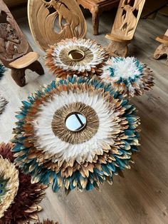 an arrangement of sunflowers and other decorative items on the floor next to a wooden table