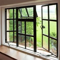 an open window with the view of a green field