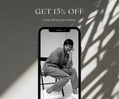 a man sitting on a chair in front of a cell phone with the text get 15 % off your first purchase