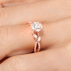 a close up of a person's hand with a diamond ring on their finger