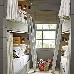 two bunk beds in a room with white walls and curtains on the windowsills