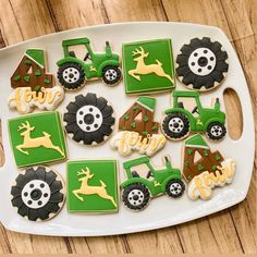 decorated cookies on a platter with tractors and farm animals