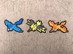 three pixellated pieces of different shapes and sizes on the ground next to each other