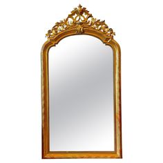 an ornate gold framed mirror against a white wall