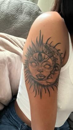 a woman with a sun and moon tattoo on her arm