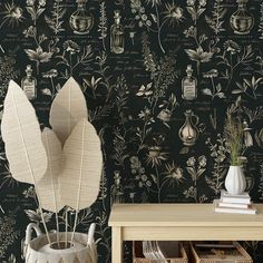 the wallpaper is black and white with flowers, plants and bottles on it's sides