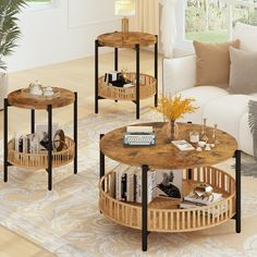 three wooden tables with books on them in a living room next to a white couch