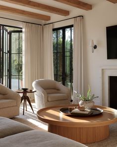 a living room filled with furniture and a fire place