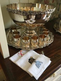 silver dishes and napkins on a wooden table