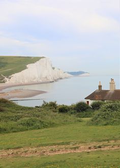 the white cliffs are visible in the distance from this grassy area, with houses on either side