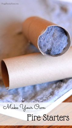 a rolled up piece of paper sitting on top of a wooden table next to a roll of toilet paper