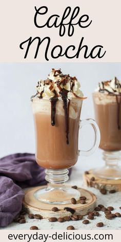 coffee mocha with whipped cream and chocolate on top is served in two glass mugs