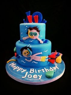 a blue birthday cake with an image of a boy swimming on the bottom and under the words happy birthday joey