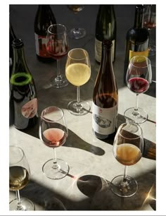 several different types of wine are lined up on a table