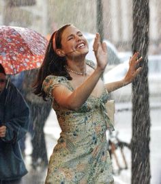 a woman standing under an umbrella in the rain