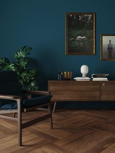 a living room with teal walls and wooden flooring is pictured in this image